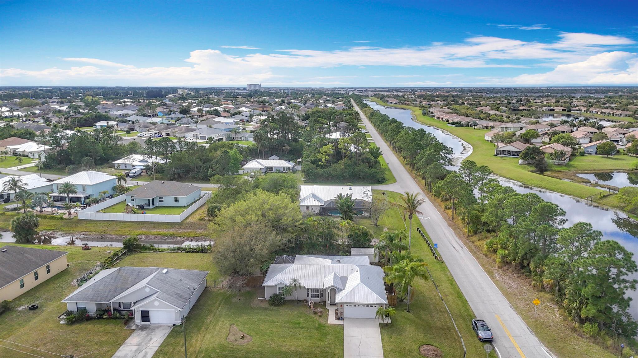 This beautifully updated home in a prime Port St. Lucie location Just 15 miles to Jensen Beach! offers charm, style, and durability. Featuring tile, engineered hardwood, and laminate flooring, it boasts elegant upgrades like 6-inch baseboards, crown molding throughout, and plantation shutters. The kitchen and bathrooms shine with granite countertops, while a spacious, fully fenced backyard includes a large 12' x 16' storage shed for added convenience. An exceptional highlight of this home is the expansive 13' x 36' air-conditioned and heated bonus room adjacent to the kitchen, perfect for a family room, home office, or entertainment space.