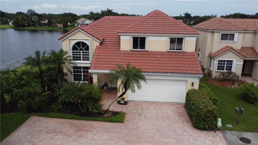 Unique 4-bed, 2.5-bath home with stunning lake view. New roof, newer air conditioner and 1 week old water heater.   Situated on a water-surrounded lot, this 2084 sq. ft., 2-story gem is truly one-of-a-kind. Features a pool, spa, covered lanai, and abundant natural light. Located in sought-after Forest Ridge, Davie, FL, near schools, highways, shopping, and more. Accordion shutters throughout  Community offers pool, tennis, cords, walking trails. 1st-floor master, ample storage, 2-car garage and enough parking for 6 cars in the dead end driveway.    Laundry room, porcelain tile, fresh paint. HOA $200/month.  Forest Ridge community has tennis courts and a community pool.    Don't miss out.
