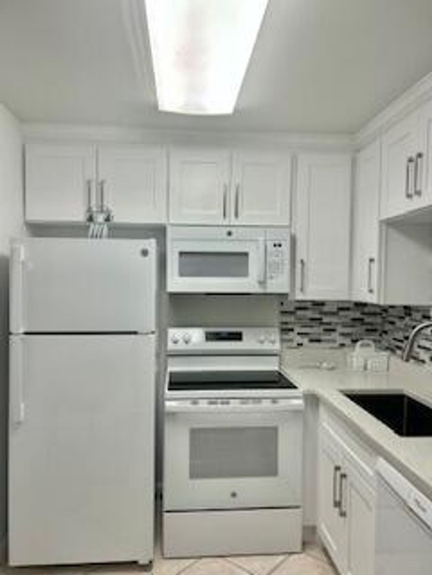 Beautifully remodeled 1-bedroom, 1.5-bath first-floor condominium located in the desirable 55+ community of Century Village West Palm Beach. This unit was fully updated in 2025 and features a new A/C, water heater, and modern finishes throughout. Enjoy the convenience of first-floor living with a parking space located directly in front of the unit for easy access. The building also features a new roof completed in 2023. Ideally situated near the community laundry facilities and includes access to additional storage space. Residents enjoy resort-style amenities, including clubhouse, pool, fitness center, and social activities. Centrally located near shopping, dining, medical facilities, and major highways including the Florida Turnpike.