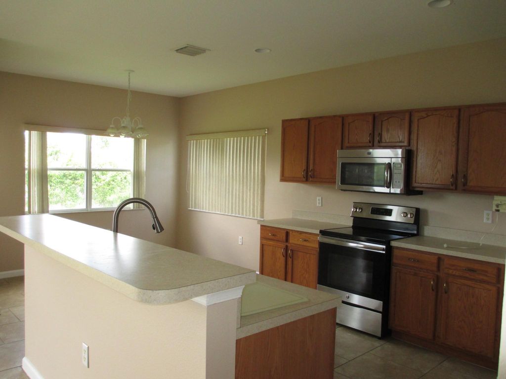 Photo of 3656 SW Ballweg Street, Port Saint Lucie, FL 34953 (MLS # R10970997)