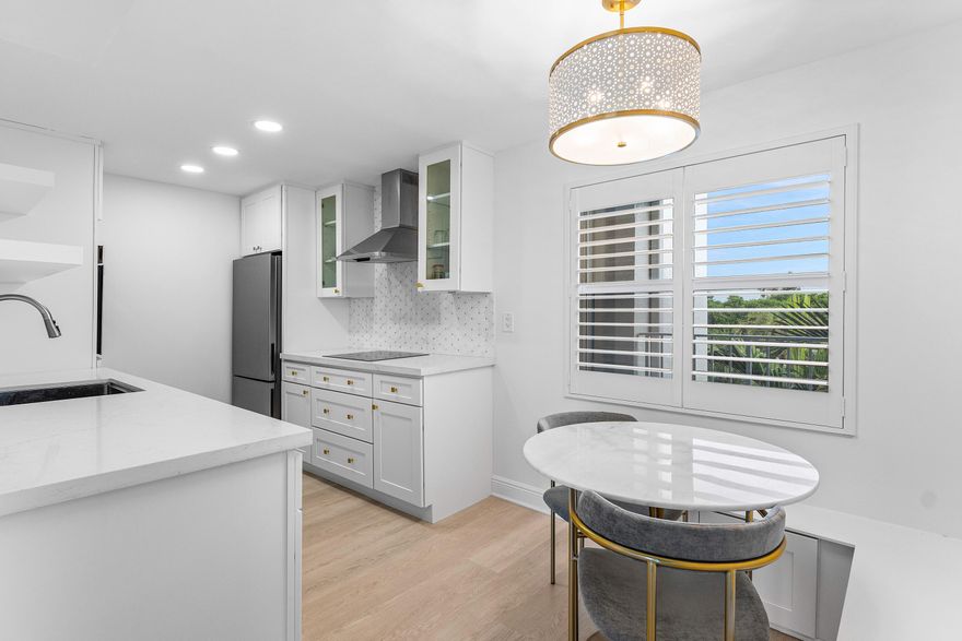 INTRACOASTAL VIEWS FULLY RENOVATED! Experience waterfront living at its finest in this beautifully renovated penthouse on the Intracoastal. Filled with natural light throughout, this bright and airy one bedroom, one bath residence features a sleek walk-in shower and a spacious bedroom with plantation shutters framing exceptional water views, plus a generous walk-in closet with custom built-ins. A coastal-inspired custom bookshelf in the hallway leads to the primary bedroom, adding both charm and functionality. The thoughtfully designed kitchen showcases quartz countertops, a wall oven, open-concept shelving, and abundant cabinetry with drawer storage, all seamlessly flowing into the inviting eat-in dining area. The open living room captures sweeping water views watch boats glide in or enjoy the community kayaks launching from the dock. Step onto the screened-in balcony overlooking the tranquil nature preserve, the perfect setting for morning coffee or evening sunsets. Every detail has been elevated to combine modern elegance, coastal character, and the tranquility of waterfront living. This penthouse is ideal for those seeking a low-maintenance lifestyle, unmatched views, and direct access to nature.