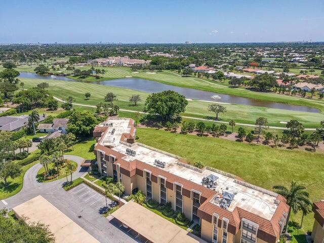Welcome to this beautiful 2-bedroom 2-bath condo in the prestigious Woodland Lakes - a 55+ community. The eat in kitchen features white wood cabinetry, granite countertops, white tile flooring, white appliances, and recessed lighting. This kitchen opens to a wonderful, enclosed porch with tile flooring and sliding glass doors where you can enjoy your morning coffee while overlooking lush golf views. The living and dining rooms feature luxury vinyl flooring, fresh paint, crown moldings, and large impact glass windows overlooking magnificent golf views. The primary bedroom is light and bright with Berber carpeting, crown moldings, fresh paint, and two walk-in closets with custom shelving and ample storage. The primary bathroom is updated with new custom wood cabinetry,