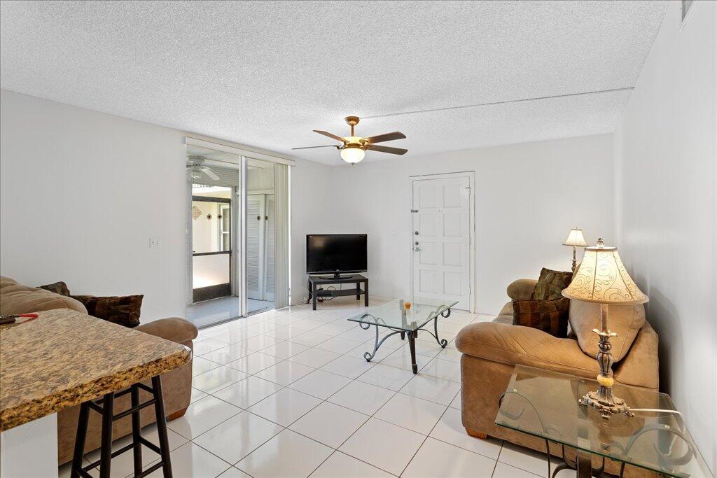 Affordable east Boca living! Ground floor 2-bedroom 2-bath condo with peaceful, yet private garden view. The kitchen features granite counters and wood cabinets. Ceramic tile in main living areas and laminate in the bedrooms. No carpet! Community W/D right outside your front door. Apartment does have W/D hookup. Stylish retro bathrooms. Large master bedroom with deep walk-in closet. Private patio with serene garden view. Located steps to community pool and clubhouse. The practical side of you will love the reasonable condo fees and the 2024 roof. Assigned parking. Pets welcome; 25 pounds or less. All age community. Primary residents may qualify for as little as 10% down. Ask me. Close to Mizner Park, stunning beaches and all downtown Boca Raton has to offer. Call now!