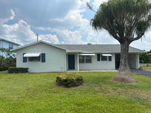 Redone 2 bedroom/2 bath single family home with large screened in patio located in Tequesta/Jupiter. Brand new gorgeous kitchen with stainless steel appliances. Many other upgrades throughout the home. Bright home with lots of natural light. Terrazzo floors. Interior and exterior freshly painted. Covered carport. Large backyard.Tequesta is a quaint yet bustling town with plenty of activities including the beach, parks, short distance to restaurants, coffee shops, and shops. Come call this home! You won't be disappointed.