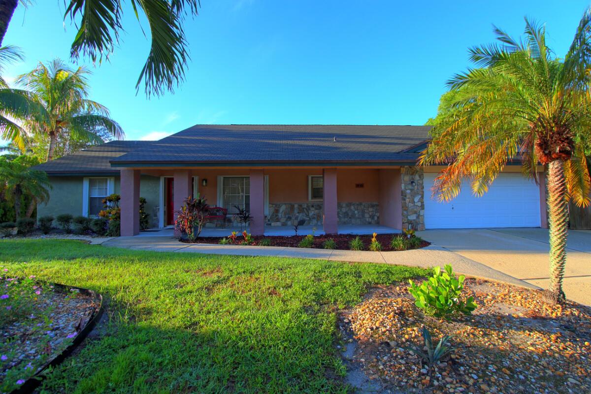 Welcome to your private retreat on a half-acre of beautifully landscaped land with total privacy, lush gardens, and a sparkling pool--just minutes from SR-7/441 and all that Wellington has to offer. With NO HOA, Residential Agricultural zoning, and room for your RV, boat, or work vehicles, the possibilities are endless. Inside, an enormous great room with vaulted ceilings and a fully functioning stone fireplace flows into an open kitchen with island cooktop, perfect for entertaining. The master suite offers a walk-in closet, dual sinks, a jetted tub, and a separate tiled shower. Step outside to your backyard oasis with pool, patio, and gardens framed by a tranquil lake backdrop. This stunning 3-bed, 2-bath home balances country living with modern convenience.
