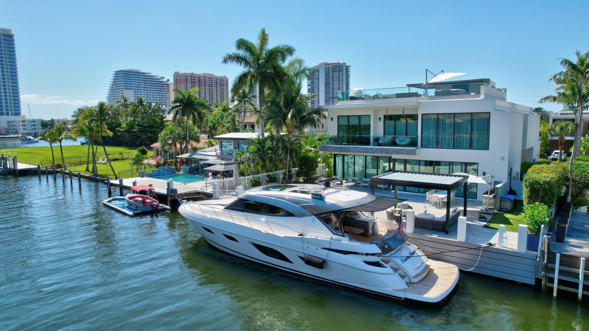 Incredibly stunning, fully furnished contemporary deepwater residence in prestigious guard-gated Seven Isles! 2025 seawall & dock! Thoughtfully designed floor plan—beyond the expansive great room, enjoy a spacious dining area, wine cellar, butler’s pantry & chef’s kitchen with gas appliances, plus an oversized island for entertaining & casual dining, all with pool & waterfront views. Professionally decorated! First-level ensuite bedroom. Elevator to open loft/bonus room, generous secondary bedrooms, and an ultra-luxury primary suite with a private balcony, spa bath & large closets. The rooftop terrace is an entertainer’s dream, finished to the highest standard with breathtaking 360-degree Intracoastal & downtown views. Just minutes from Las Olas dining, shopping, beaches & airports.