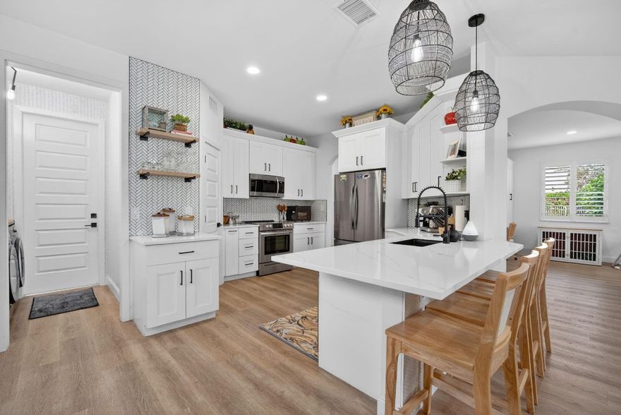 This beautifully updated home has been fully redone from top to bottom—no detail was overlooked. Enjoy peace of mind with new hurricane-impact windows, new roof, new flooring, new kitchen, and new bathrooms. Every major system and finish has been updated, making this home truly 100% turnkey. The bright, open layout, white oak-look flooring, modern kitchen, and spa-inspired bathrooms create a fresh, clean, contemporary feel. Located on an oversized lot on a cul-de-sac in a quiet, family-friendly neighborhood with low HOA, residents also enjoy access to two community pools, a clubhouse with fitness center, playgrounds, and designated pet areas, adding to the lifestyle appeal. Just bring your furniture—everything else is already done.