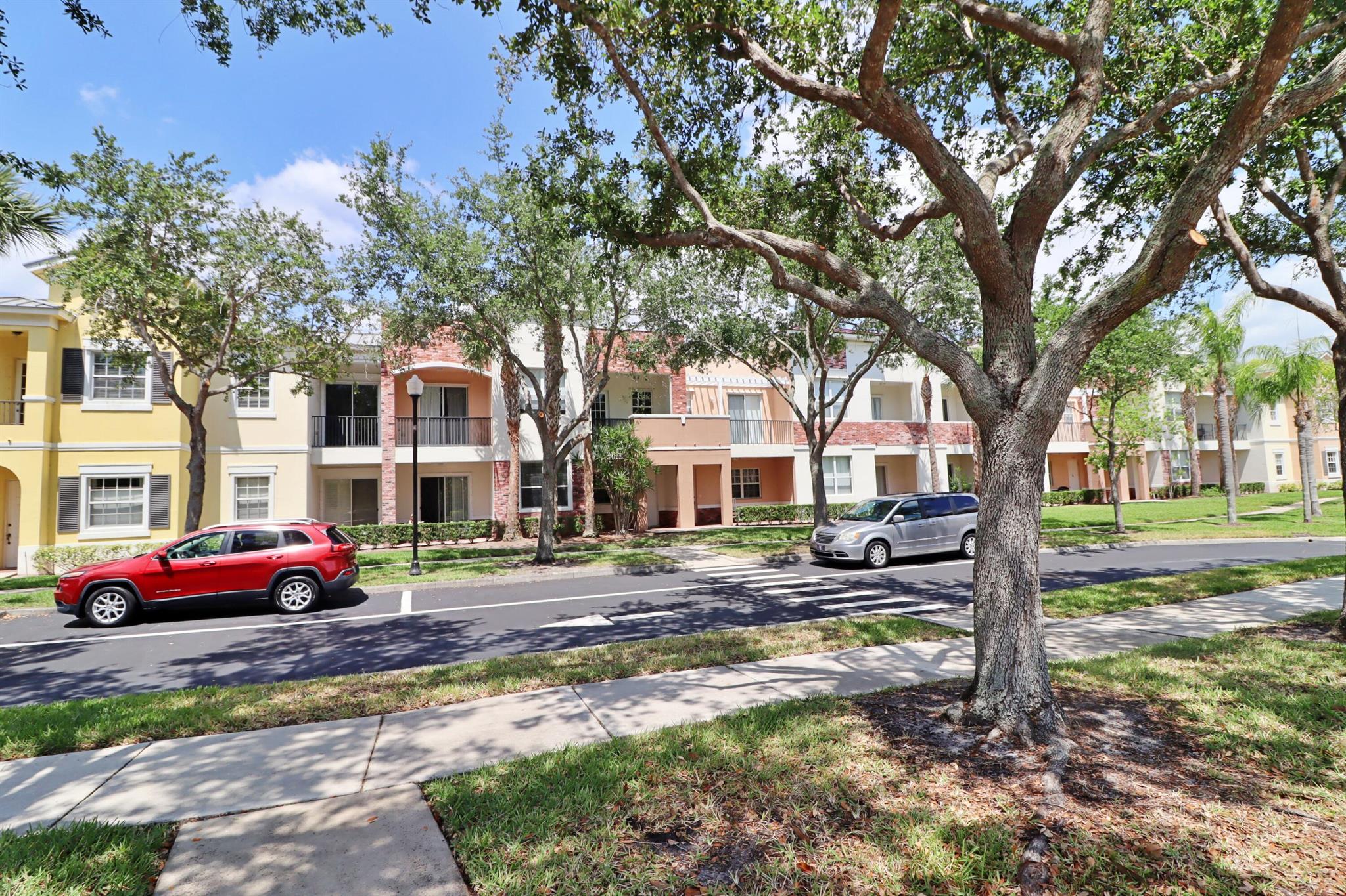 Discover this tranquil, chic, and sunny 2nd-floor condo in the coveted Promenade at Tradition with pool and tropical green space views. Nestled in the heart of Tradition Square, just 2 blocks from vibrant restaurants, the green market, Publix, schools, parks, and rec. Open floor plan with ample storage, 2 balconies, and spacious bedrooms. The elegant primary suite has 2 walk-in closets, linen closet, separate tub, dual sinks and shower. Enjoy luxury features such as high-end LVP flooring, 18'' tile, 8 ft doors, LED lighting, S/S appliances, 9 ft ceilings in living areas, fresh paint (2023), 2017 roof and oversized 1-car garage (27x12) with high ceilings. In immaculate condition, this condo offers the charming downtown lifestyle you've dreamed of, with major stores just blocks away.