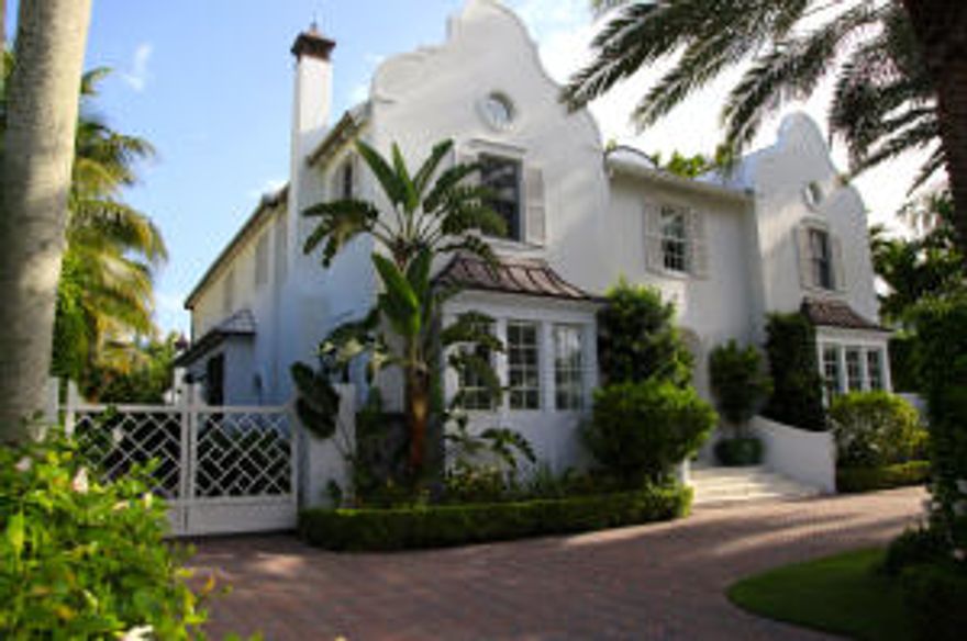 No detail has been spared in this sophisticated Island masterpiece. Designer finishes throughout and located on highly sought after Tangier Avenue close to the Lake Trail, beach, shopping and restaurants. Make a grand entrance in the sun drenched foyer where a hand carved spiral staircase opens onto the most gracious living room, library/guest suite, dining room, and den with walnut hardwood flooring throughout. Imagine your very own Nancy Meyers movie  kitchen come to life, with white-on-white custom cabinetry, marble countertops, and top of the line appliances, including dual Bosch dishwashers, dual Wolf ovens, Thermador cooktop, and integrated Sub-Zero refrigeration. Fix a cocktail or coffee in the attached butler's pantry, featuring refrigerated drawers, ice maker, wine storage, and