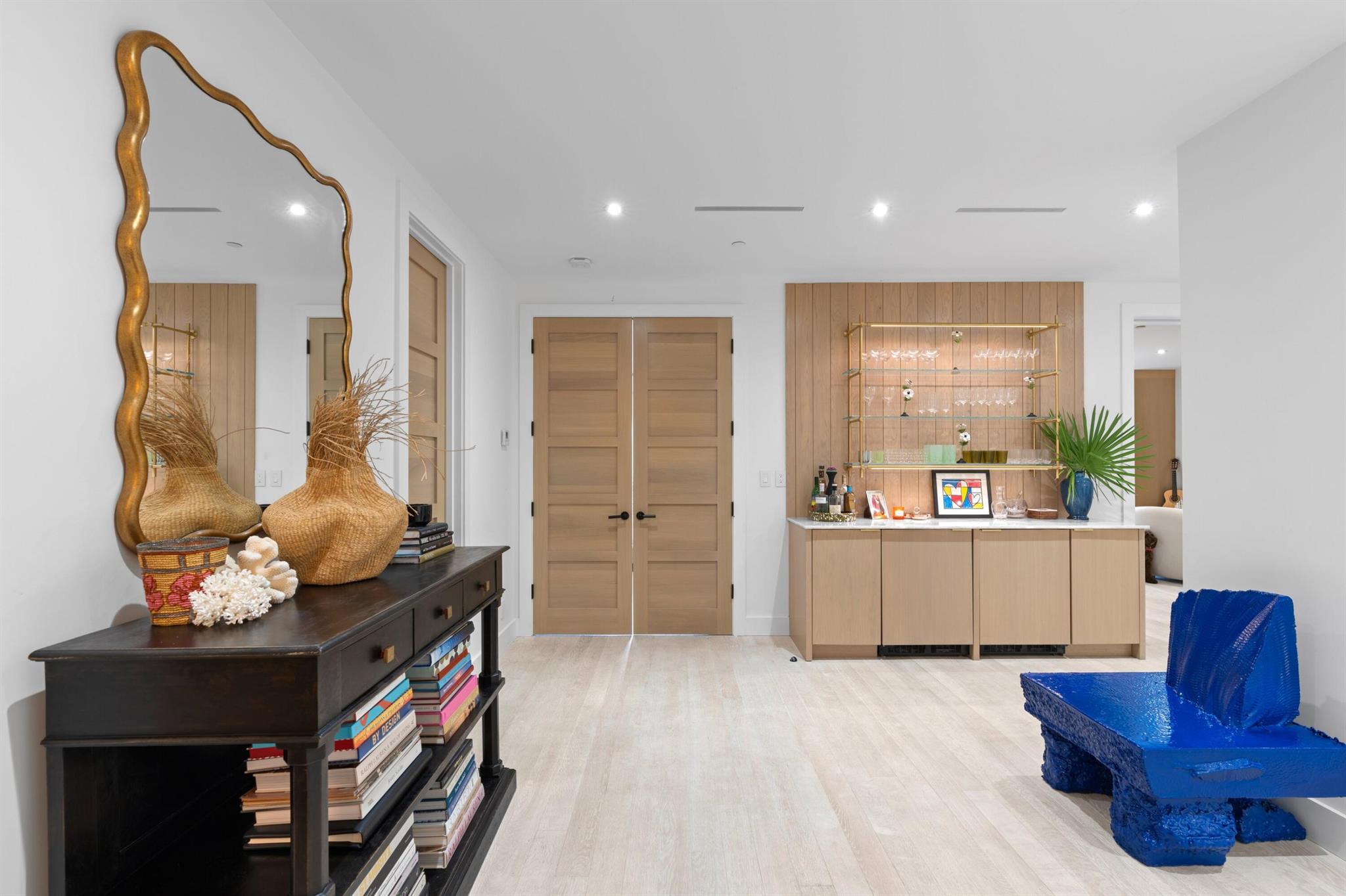 Welcome to this newly top-to-bottom renovated first-floor residence designed by Jeff Lincoln at the renowned Palm Beach Biltmore. Featuring wide plank white oak wood flooring throughout and some of the finest finishes available today.Currently configured as a one-bedroom with two full bathrooms, it offers the flexibility to be easily converted into a two-bedroom if needed. A versatile second living area, enclosed by large sliding wood custom doors, can serve as a private second bedroom.The thoughtfully designed kitchen boasts quartz countertops, a Wolf induction cooktop with external venting, a Wolf oven, and a panel fridge and freezer with an ice maker.The open layout includes a dining area that flows seamlessly into the living room, enhanced by a wall of custom cabinetry for