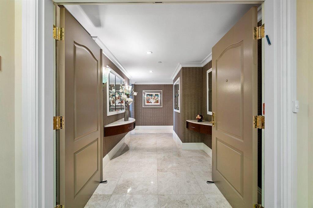 Architect's personal residence, substantially upgraded and decorated; can be offered finely furnished and fully turnkey. Elegance awaits in this spacious corner 3 bed 3 1/2 bath condo in the heart of Downtown Boca Raton. As you enter through the double front doors and pass through the private foyer adorned in silk wall coverings, you are greeted with abundant natural light. Floor to ceiling impact windows lead to 3 spacious covered balconies, totaling 300 sq ft. Meticulously crafted, the home features coffered ceilings, custom cabinetry and draperies, hard surface flooring throughout, stainless steel Thermador Appliances, paneled refrigerator, Miele in-wall coffee machine and granite countertops.The primary suite has two walk-in closets and bathroom en-suite, with double vanity, whirlpool