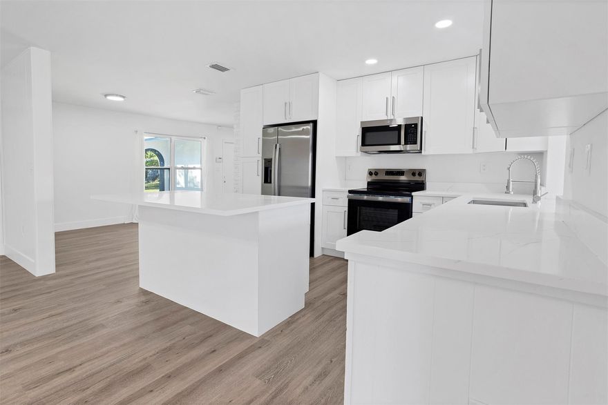 This beautifully remodeled Lauderhill home offers 3 bedrooms, 2 bathrooms, and bonus room with 2 car garage. The heart of the home features a brand -new designer kitchen with white shaker cabinets, quartz countertops, a large island and new stainless steel appliances. New wood-style flooring. Bathrooms renovated with sleek finishes, including a luxurious tub with marble look. Step outside to a private backyard with a pool, perfect for entertaining. Additional upgrades include a new roof, fresh interior paint. NO HOA. Prime location near shopping, major highways and schools. Turn Key and ready to move in- schedule your showing today!