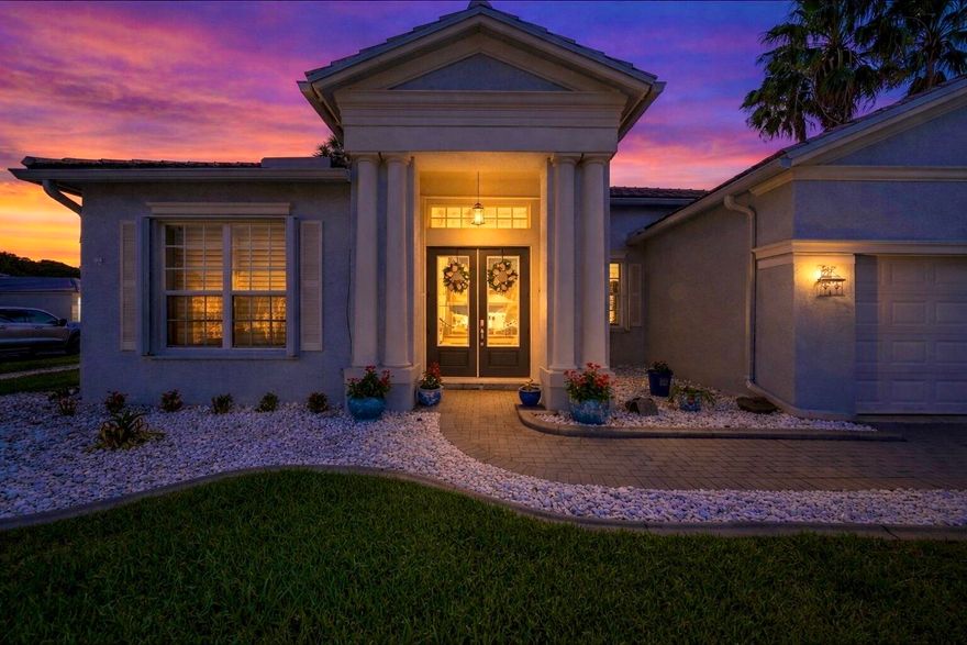 Graceful architecture and refined updates come together in this beautifully appointed 3-bedroom, 2-bath residence where soaring ceilings, elegant finishes, and thoughtfully designed living spaces create an atmosphere of comfort and sophistication. A striking columned entry welcomes you inside to light-filled interiors and an open layout designed for both relaxed living and stylish entertaining. The formal dining area flows seamlessly into the main living space, enhanced by custom plantation shutters and abundant natural light. At the heart of the home, the newly redesigned chef's kitchen (2026) features sleek cabinetry, dramatic stone surfaces, modern appliances and a hidden walk-in pantry with a dedicated appliance station,  offering exceptional storage while keeping the main kitchen clean and uncluttered. The primary suite offers a peaceful retreat, complete with spacious walk-in closets and a luxurious bath featuring dual vanities, a soaking tub and separate shower. Two additional bedrooms provide flexibility for guests and family. In addition to the three bedrooms, the home features a versatile flex space currently used as a display room, offering endless possibilities as a home office, hobby studio, library, or private retreat.  Thoughtful updates add both style and peace of mind, including a new roof (2022), plantation shutters (2022), exterior hurricane shutters (2024), and an updated guest bathroom shower (2025).  Beautifully maintained and truly move-in ready, this residence blends timeless elegance with modern updates. The expanded enclosed patio, creates a bright Florida room surrounded by windows and privacy panels. Finished with tile flooring and cooled by an oversized ceiling fan, this inviting space provides the perfect setting for relaxing, entertaining, or enjoying peaceful indoor-outdoor living.  Set on a corner lot in the beautifully-manicured, gated community of Lake Forest. Residents enjoy some of the lowest association dues in the desirable St. Lucie West area, which include lawn maintenance along with cable and internet for added convenience and value. Lake Forest offers exceptional community amenities, including a clubhouse with a fully equipped fitness center, two resort-style swimming pools with cabanas, a relaxing spa, and a playground for younger residents. The community's active Activities Committee regularly hosts events that bring neighbors together, including family game nights, cooking classes, craft events, bingo, and seasonal gatherings — creating a vibrant and welcoming atmosphere. Lake Forest is truly a beautiful place to call home, where comfort, community, and lifestyle come together.