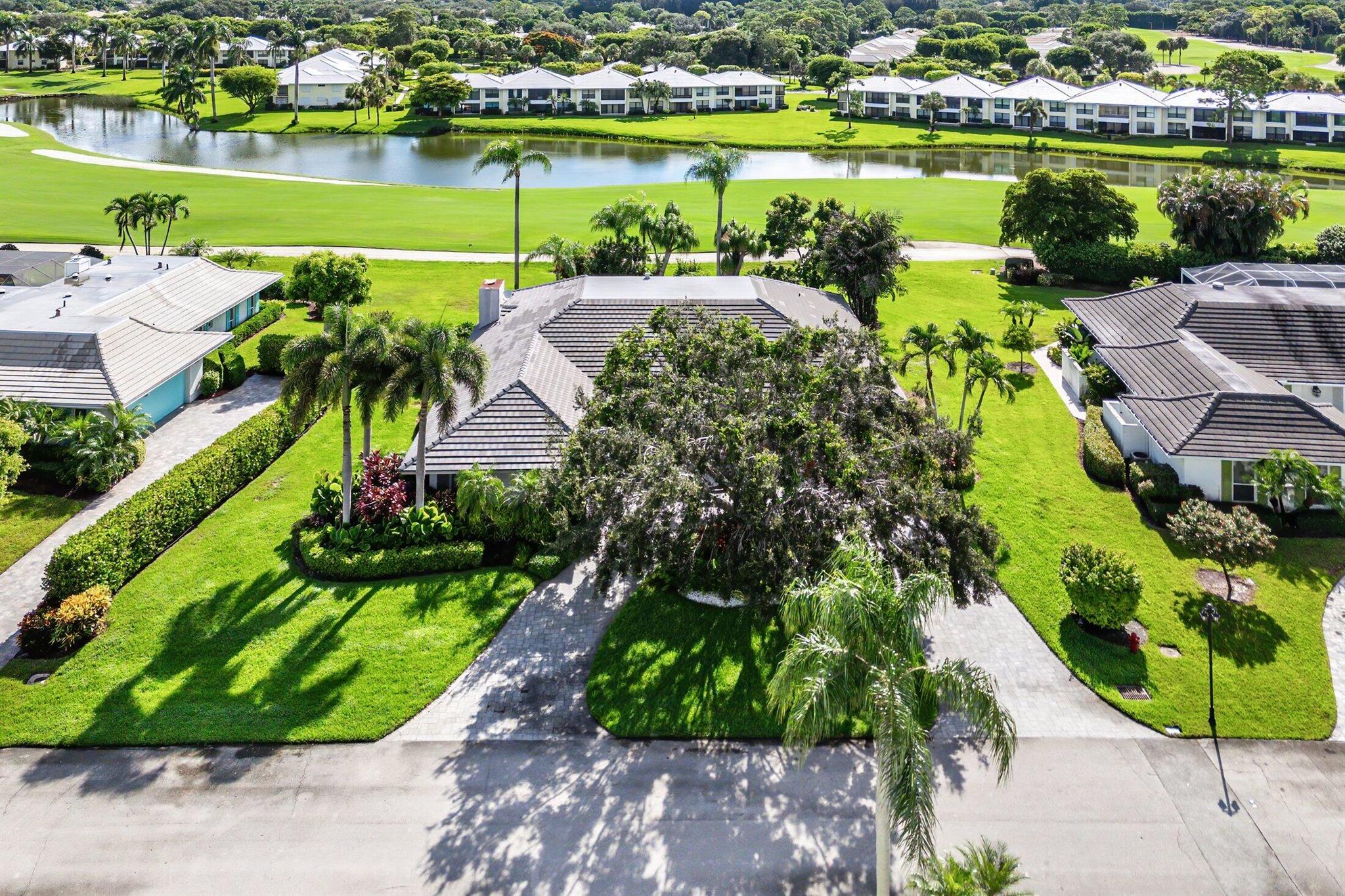 Beautiful lake & golf views in this beautifully updated 4-bedroom, 3.5-bath custom home in the Partridge area of Quail Ridge. Designed for comfort and entertaining, this residence offers lots of special details: bay windows, living & dining rooms and a welcoming great room with a wet bar & cozy fireplace and gorgeous open kitchen.The thoughtfully designed floor plan includes generous living spaces, each filled with natural light. Step outside to a beautifully paved patio perfect for al fresco dining and gatherings, or relax on the covered screened porch. Additional highlights include a 2-car garage, a convenient circular driveway for guest parking, and timeless architectural details throughout. Quail Ridge is a mandatory membership private club community.