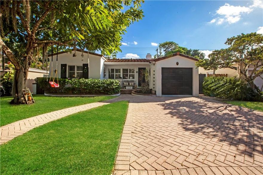 Welcome Home to Rio Vista, one of E. Fort Lauderdale's most coveted subdivisions. Warm, cozy, tranquil, updated are just a few of the adjectives to describe this quintessential residence. Mature landscaping with hanging Spanish moss sets the entry to a covered porch & original doorway. The living and dining room share warm wood flooring and a classic fireplace. The updated kitchen overlooks the breakfast area and opens onto a spacious family room with doorways that blend indoor and outdoor living spaces. The primary suite offers two walk-in closets and a bathroom complete with dual sinks, a separate shower & whirlpool spa. The 2nd bedroom is spacious in size & the 3rd bedroom with bathroom is currently used as a home office. A covered loggia overlooks the pool & garden. Sq ft from IMAPP