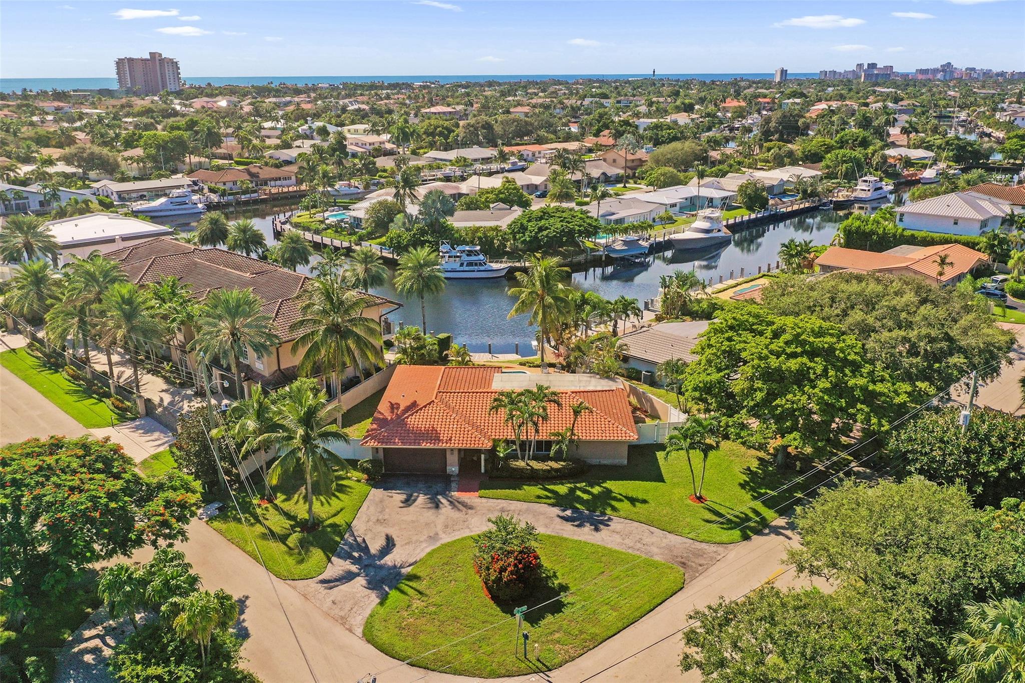 Wonderful opportunity to live in one of the most desirable sections of Venetian Isles! Perfectly tucked away on a quiet interior street, this home sits on an extra-large lot offering incredible wide-water views w/ no fixed bridges to the ocean. Desirable, split-bedroom floor plan provides excellent privacy. Spacious primary suite opens directly to a huge covered 30 ft lanai boasting stunning views of the pool & waterfront. Interior features include tile flooring in the main living areas & beautiful wood-look porcelain tile in the bedrooms. Lovely open kitchen was tastefully updated in 2017 w/ rich granite counters & premium Bosch appliances. Located less than 1 mile from Lighthouse Point Yacht Club, this home combines privacy, space, & premier waterfront living — a true boater’s paradise!