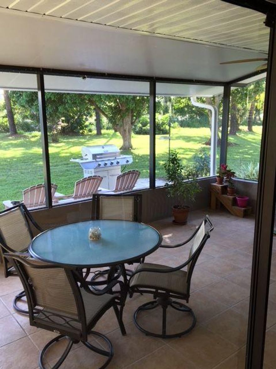 Included at the end of the photos are pictures of neighboring houses so you can get a feel for the entire community. This is a wonderful concrete block/stucco home with a quality metal roof that is only 7 years old. The ground is over an acre with beautiful views in every direction, and frequent wildlife surprises. It is in a wonderful gated community with great neighbors, peace and quiet, and space to be left alone if you so desire. The home is very comfortable with a very large kitchen/den, large bedrooms, and the feel of a much larger home. Must see the beautiful interior complete with working fireplace. You'll love living here. Plus, we have the lowest HOA fees in Martin County. Live large and save money.