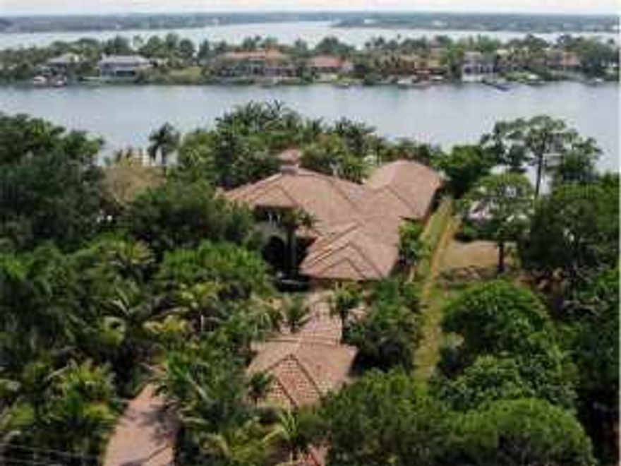 **Motivated Sellers** This magnificent Mediterranean-inspired, riverfront estate is nestled on a stunning home site of approximately one acre and boasts almost 9400 sq. ft. under air. Its impeccable design offers 5 generous bedrooms within the main home, an open and airy main living area with soaring, custom ceilings, home theater/media room, gourmet kitchen, spacious master suite with sitting room, fitness room & extra large walk-in closets, and home office/den with spiral stairway to an open loft area perfectly planned with wet bar and large enough for a billiard table. The comfortable & roomy, screened lanai features a summer kitchen and cozy fireplace. In addition, there's a private 2BR/2BA, fully equipped guest house and a 6-car, air-conditioned g... (see supplement for full remarks) **Motivated Sellers** This magnificent Mediterranean-inspired, riverfront estate is nestled on a stunning home site of approximately one acre and boasts almost 9400 sq. ft. under air. Its impeccable design offers 5 generous bedrooms within the main home, an open and airy main living area with soaring, custom ceilings, home theater/media room, gourmet kitchen, spacious master suite with sitting room, fitness room & extra large walk-in closets, and home office/den with spiral stairway to an open loft area perfectly planned with wet bar and large enough for a billiard table. The comfortable & roomy, screened lanai features a summer kitchen and cozy fireplace. In addition, there's a private 2BR/2BA, fully equipped guest house and a 6-car, air-conditioned garage. Stately columns, archways and French doors open to a tropical retreat and resort-style, waterfront entertainment area featuring an over-the-top pool and spa with its own waterslide and lazy river, sport court, fenced tot lot and putting green, all surrounded by lush, Polynesian-style landscaping and towering coconut palms. Unwind under the tiki hut and watch the sun set and boats go by. This exceptional residence is located just minutes to the Jupiter Inlet and offers sweeping river views, a private, gated entrance and fully equipped dock with 3 lifts, water & electric.