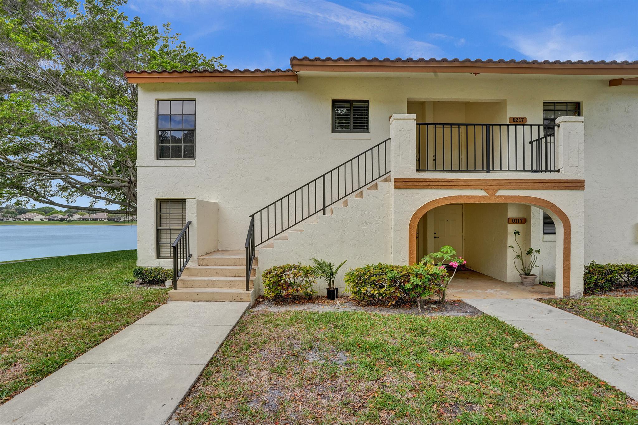 Discover this exceptional 2-bedroom, 2-bathroom split-plan condo in the highly desirable Lake Windwood community of East Boca Raton. This sunny, corner unit boasts vaulted ceilings, a thoughtfully renovated kitchen with high-quality wood cabinetry, granite countertops, subway tile backsplash, and a reworked layout that maximizes counter and storage space--making it feel much larger than comparable units!Step outside to your huge screened-in balcony, where you'll enjoy serene waterfront views of the lake, lush green space, and the peaceful wildlife preserve. The unit also features in-unit washer and dryer, a newer AC (2021/2022) and water heater (2021) for added efficiency and peace of mind.