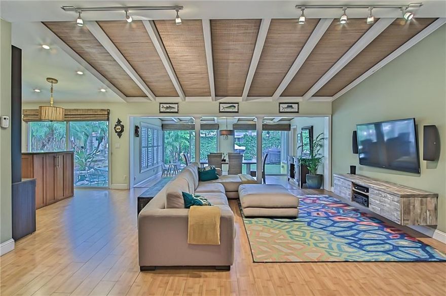 Beautifully updated waterfront home featuring 2 bedrooms plus den in main home plus separate 1 bed/office. Open living area offers high ceilings, wood floors, & is ideal for entertaining w/open kitchen including stainless steel appliances & incredible views of your lush tropical backyard. Spacious master closet & bath with two sinks, separate shower & tub. Low maintenance artificial turf & no fixed bridges. Relax under the Tiki Hut watching the game or jump in the heated pool after a long day on the boat!