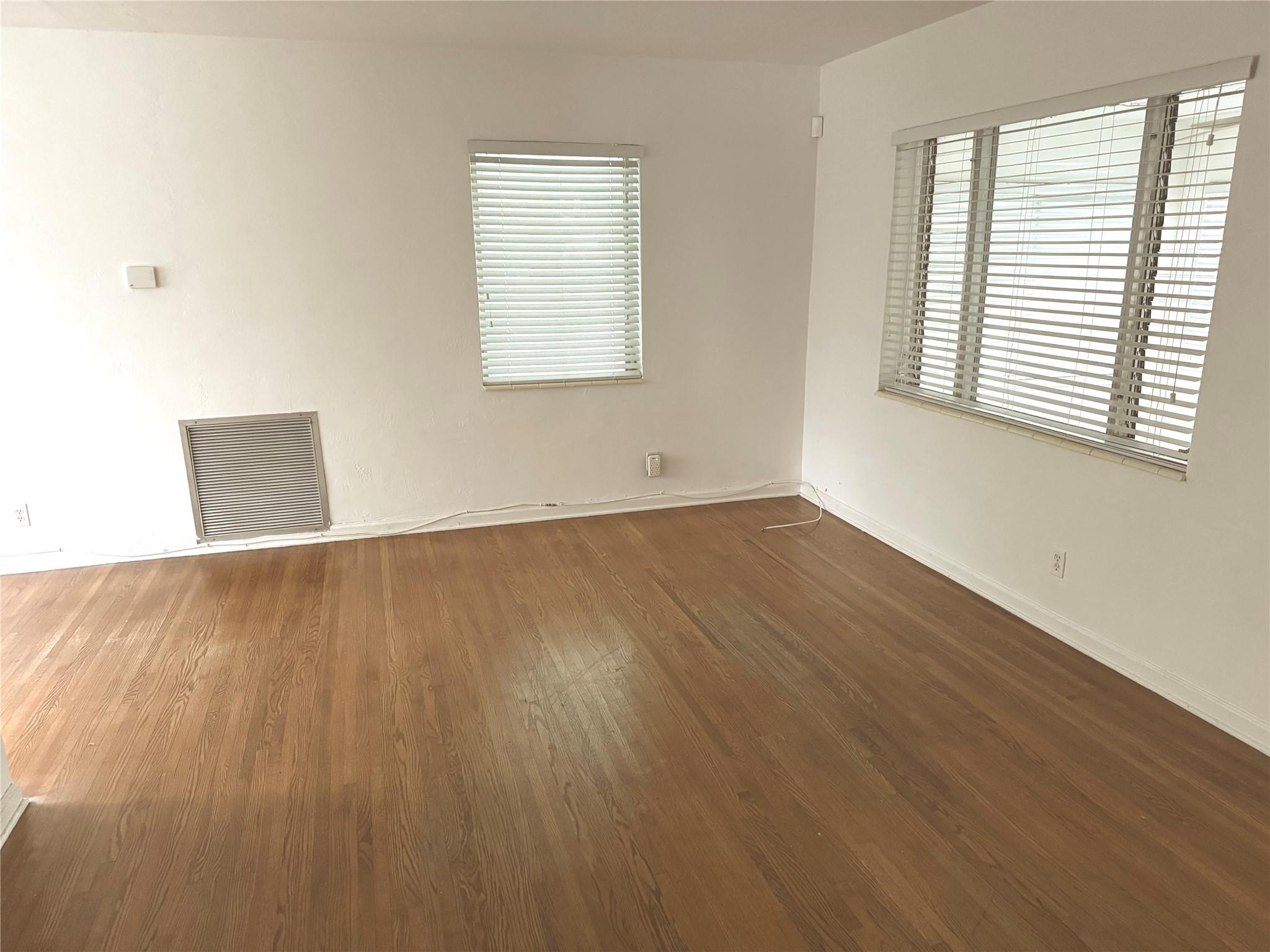 Light & Bright with BONUS additional front room. PET friendly with large FENCED yard. Prime location! Full size Washer and Dryer in attached spacious Utility/Storage room. Central A/C . Wood floors with tile in wet areas. Attached Carport and private drive for added convenience. Detached Private house, 2 miles to beaches and amazingly convenient to everything! No HOA! Available immediately! Must see. Lawn mowing included