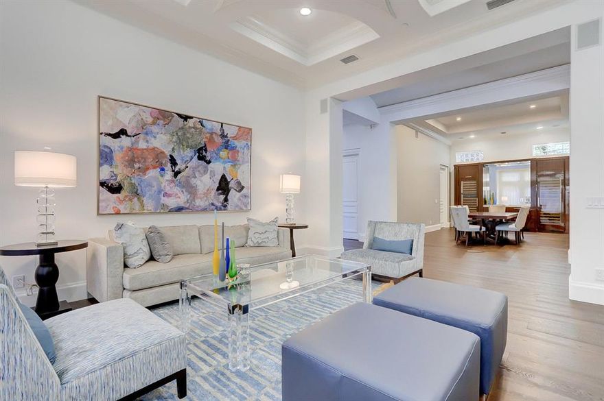 ABSOLUTELY stunning home for the most discriminating tastes.  As you enter into the elegant foyer you feel the sophisticated splendor of the home.  20' ceilings and totally updated with the finest finishes, this transitional interior has all the custom elements that make it unique and special.  Ocean Cove is an exclusive private enclave of 22 homes, deeded beach access and marina to dock your yacht. THIS IS A UNIQUE & RARE OPPORTUNITY.  European chef's kitchen with Sub Zero, Wolf and Miele appliances, including an 8-burner gas stove, 2 dishwashers, 2 sinks, ice maker and beverage drawers. Gorgeous marble countertops with glass tile backsplash and pot filler above stove. Great for entertaining, the French doors take you from the breakfast area and large family room outside to the salt-water pool and summer kitchen in the completely private back yard which backs up to a 10.5 acre nature preserve.   Formal dining room with built in wine storage (temperature controlled) for 500+ bottles.  Living room gives another area for entertaining with a contemporary electric fireplace.  Plenty of wall space for your art collection, and guest bedroom/office downstairs with its' own patio.  Gorgeous natural wood floors throughout the first floor. 
Upstairs is a spectacular master bedroom suite, 2 en-suite large bedrooms, and an open loft area.  The master has a coffee bar, his and hers' baths, huge closets and a terrace overlooking the pool and private back yard. Each bedroom is completely private with a large closet and full bath.  The loft is a large open area adding lots of space for hanging out and relaxing, or for your private gym.  High ceilings throughout and a private elevator. 
Ocean Cove is an exclusive private enclave of 22 homes, deeded beach access and community marina directly on the intracoastal.