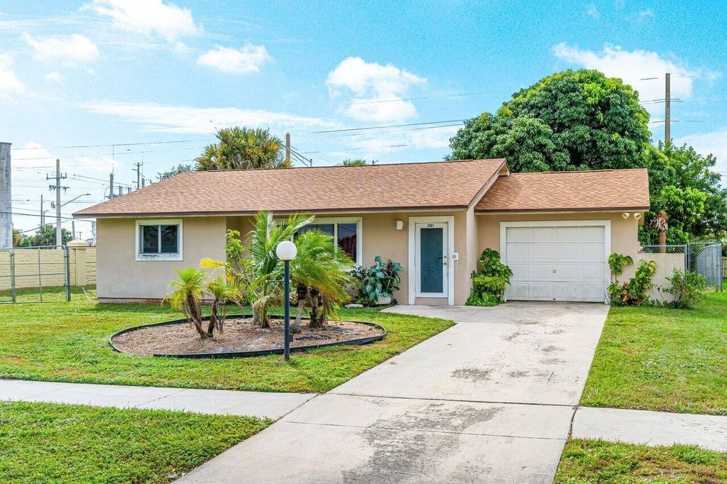 Photo of 2501 Canterbury Drive S, Riviera Beach, FL 33407 (MLS # R10930783)