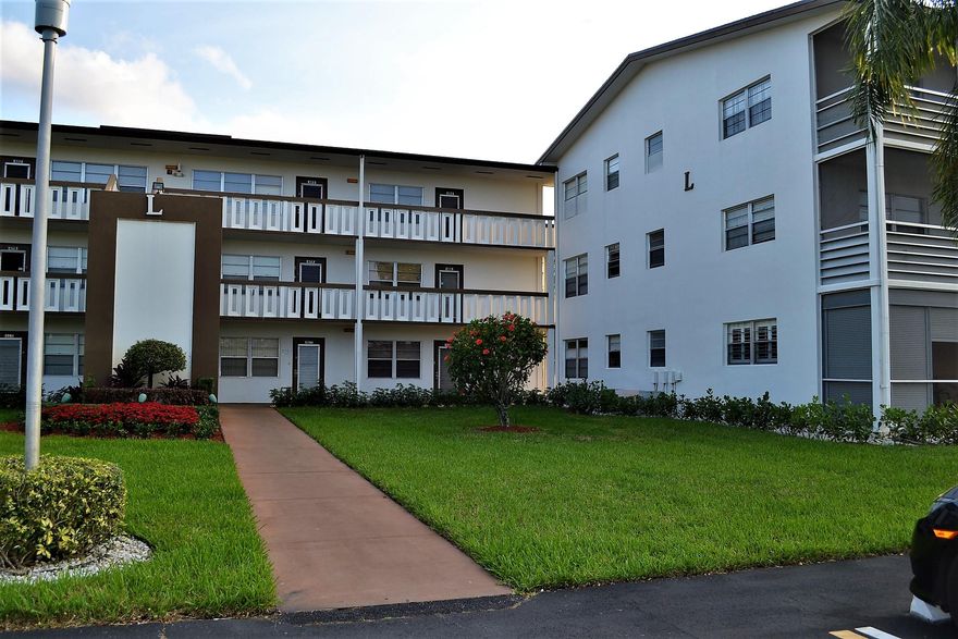 Immaculate, 1st Floor, light and bright CORNER unit. Updated kitchen has raised panel cabinets, granite look counters, and newer appliances.  Beautiful tile throughout. Newer vanity in master, updated half bath, newer a/c and hot water tank. Large bedrooms. Walk-in closet. Screened patio with beautiful tiled floor and security pull-downs.  Large storage closet on patio. Near laundry room. Close to bus stop.  Enjoy all of the wonderful amenities that Century Village has to offer - fabulous clubhouse, pools, shows, activities.  A great place to call home!