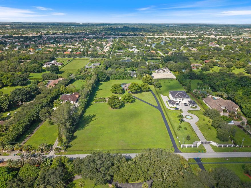 Seize one of the last remaining 5± acre estates in Sunshine Ranches, perfectly situated on prestigious Thoroughbred Lane. This private, fully fenced property offers endless potential—subdivide into two lots, build a custom compound, or design a single dream estate of over 20,000+ sq ft. The existing 4 BR / 4.5 BTH home features an updated primary suite, expansive game room with bar, oversized screened-in pool. Quiet, no-thru street location makes this one of the most coveted addresses in all of Southwest Ranches. A rare opportunity for equestrian enthusiasts, developers, or those seeking the ultimate in privacy and luxury living.