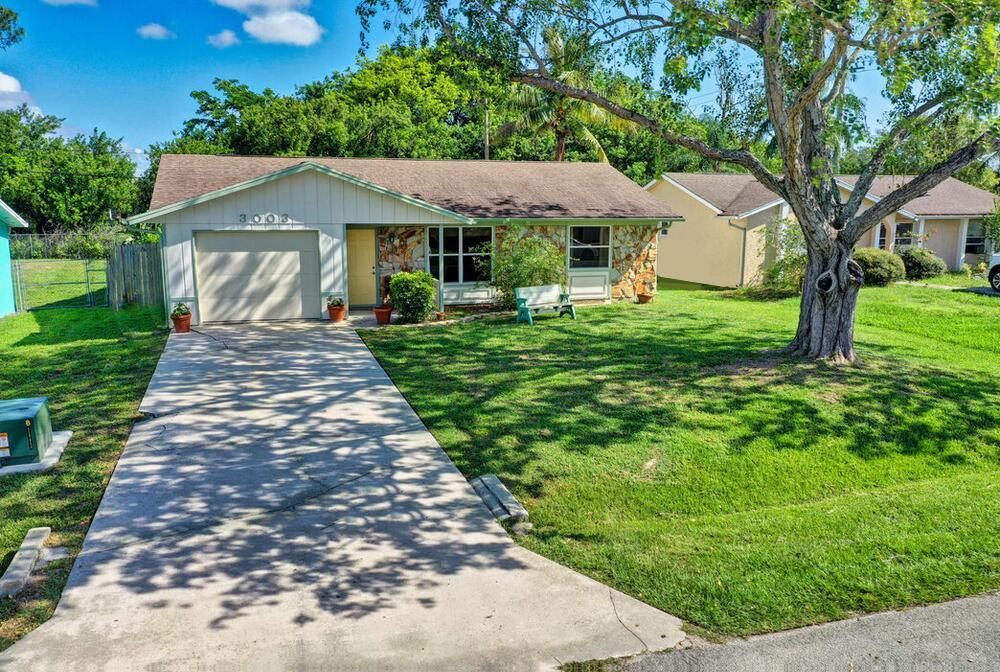 Very charming & well maintained 2 bedroom, 2 bathroom with a laundry room, Florida room, a one car garage & CURB APPEAL! Cute ranch style home w/beautiful Oak tree in the front yard & a porch to enjoy your morning coffee. Beautiful ceramic tile throughout the living area & kitchen. Updated flooring in the bedrooms & each bathroom has gorgeous tile lining the soaking tub & \ the step in shower. Primary bath has fabulous decorative tile floor. AC unit replaced in 2017 (RUUD) as is the hot water heater & electrical panel. Plenty of storage in the separate laundry room. Spacious fully fenced backyard. Septic recently maintenanced. Hullet Pest Control serviced 5-23 & property has termite service through 6-24. Check out the 3D-Virtual Tour enclosed.