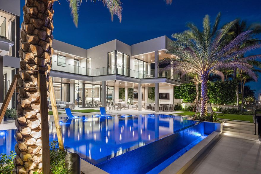 Welcome to 500 Alexander Palm Road-an Intracoastal turn-key Signature Estate by SRD Building Corp, perfectly positioned within Royal Palm Yacht & Country Club, Boca's most coveted community. Built in 2022, the home spans more than 8,200 square feet of beautifully designed, open, and airy living space. The five-bedroom residence features a 4-car plus golf-cart garage, a resort-grade pool and outdoor retreat, and 100 feet of premier Intracoastal frontage complete with a private dock and Jet Ski lift. Enhanced by full Crestron smart-home automation, advanced security features, and meticulous craftsmanship throughout, the property is offered fully furnished by the award-winning P&H Interiors--creating a seamless, move-in-ready waterfront experience.