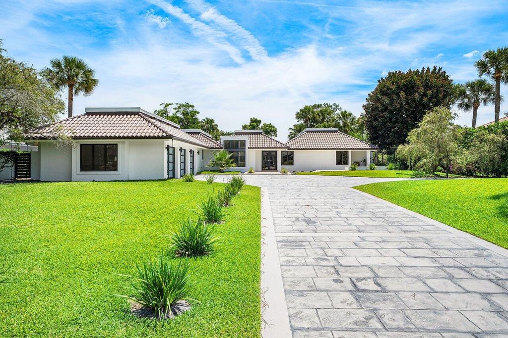 Photo of 1648 Breakers West Boulevard, West Palm Beach, FL 33411 (MLS # B26025988)