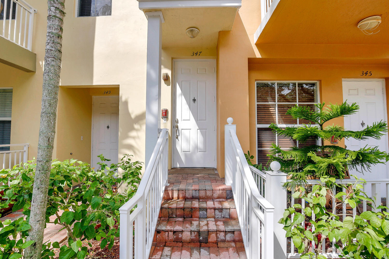 Complete update and remodel in September 2017! Paved step-up walkway leads you into this unit with a modern tone and traditional feel. A must see! Brand new wide-plank wood laminate flooring, SS kitchen appliances with granite countertops, tall baseboards, new interior hardware, wood stairs and more. Brand new A/C 2016, double oven, wide refrigerator, new bath and light fixtures throughout, upgraded mirrors and modern high-end ceiling fans. Private entry in front and rear, 1 assigned parking spot, and close to mailbox. Impact glass throughout, custom wood built-in closet shelving, with clean and bright white subway tiled baths. Laundry room with stacked washer/dryer and plenty of extra storage space with more built-in shelving. Solid construction keeps noise out and secure during storms!!!