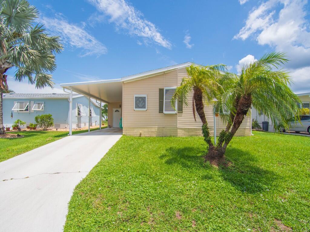 Very spacious and bright manufactured home in the welcoming community of Tropical Isles. You will love the peaceful lake view that you can enjoy from the combination living, dining, kitchen great room and enclosed Florida room. This home is very welcoming with its North/South exposure and all the windows bringing in the Florida sunshine. Included with this home are 6'' exterior walls, extra wide 52'' hallway, all kitchen appliances, irrigation system, hurricane shutters, architectural roof with self-sealing underlayment replaced in 2018, insulated vapor barrier replaced in 2020, A/C replaced in 2020, water heater replaced in 2022. Come make this beautiful home yours.