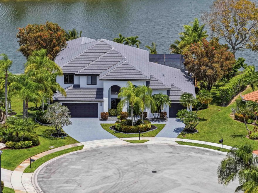 STUNNING LAKEFRONT ESTATE in Carlyle Estates, BOCA WINDS on a QUIET CUL-DE-SAC PREMIUM LOT with 186 ft of WATER VIEWS W/ FRUIT TREES. This LUXURIOUS 5BR/3.5BA + Loft & MOVIE THEATER + 3-car GARAGE home spans 4,048 sq ft Featuring NEW GOURMET KITCHEN, PROFESSIONAL LINE APPLIANCES, DOUBLE OVEN, WATERFALL ISLAND, POTFILLER, LARGE COLUMN FRIDGE + FREEZER.  The PRIMARY SUITE and GUEST SUITE are on the 1st floor; UPSTAIRS LOFT + NEW MOVIE THEATER, 3 BEDROOMS. Enjoy a HEATED SALT-WATER POOL, CABANA BATH, and UPSCALE ELECTRIC FIREPLACE + WINE RACK+WATER FEATURE. GARAGE CONVERTED GAME ROOM! ROOF 2020, FULLY IMPACT WINDOWS AND DOORS, NEW ELECTRIC PANELS, NEW A/Cs and TESLA CHARGER, TANKLESS WATER HEATER! Low HOA, TOP-RATED SCHOOLS, and close to Shopping and Highways. A TRUE WEST BOCA GEM! MUST SEE! Private SHOWINGS: Please text 617.240.4528 or Showing Time