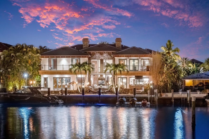 Introducing Villa Tremezzo, a privately gated West Coast Contemporary estate in Lighthouse Point's most prestigious enclave. Set behind lush landscaping and impressive stone walls, this extraordinary waterfront residence offers exceptional privacy, timeless architecture, and remarkable craftsmanship throughout.  A grand arrival leads into interiors defined by rare petrified wood stonework, rich custom millwork, and elegant Brazilian marble flooring. Designed for both luxury living and entertaining, the home features a chef's kitchen with Thermador gas appliances, six burners, Chicago brick ceiling accents, and a hidden butler's pantry. Smart home technology integrates lighting, sound, motorized shades, climate, and security throughout the residence. Resort-style outdoor living centers around a spectacular infinity edge pool with waterfalls, grotto seating beneath cascading water, spa, sun shelf, and color-changing lighting. The expansive outdoor space also features a summer kitchen, putting green, outdoor shower, fire torches, and beautifully illuminated tropical landscaping designed for unforgettable evenings.  The home offers an exceptional entertainment experience with a fully soundproof professional theater with 130-inch screen and high-end Sony projection system, along with a game room and bar.  Upstairs, a dramatic bridge hallway leads to a split-bedroom layout where each bedroom enjoys its own private terrace, walk-in closet, and en-suite bath. The luxurious primary suite features expansive terraces, spa-style bath with multi-jet shower, fireplace, custom bar, and boutique-style closets.  Additional highlights include an elevator, whole-house generator, four newer AC systems, copper gutters, whole-house water filtration and softening, central vacuum, advanced security cameras, and extensive smart-home automation.  Originally completed in 2014 and extensively upgraded, Villa Tremezzo is a rare custom-built showcase estate designed for the most discerning buyer.  The information published and provided including but not limited to prices, measurements, square footages, lot sizes, features, finishes, and calculations are subject to errors, omissions or changes without notice. All such information should be independently verified. All parties should perform their own due diligence to verify all information.