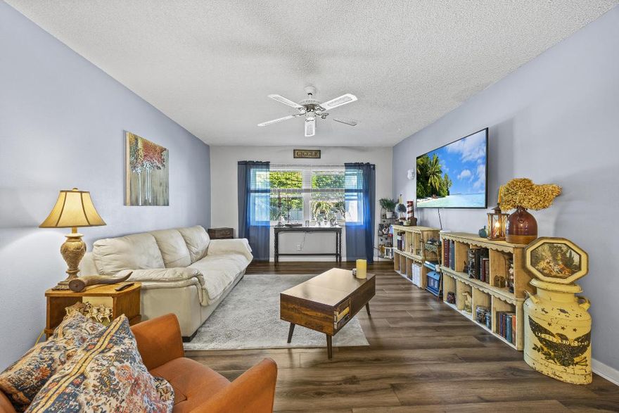 Nicely updated upstairs unit in a quiet,  2-story complex offering privacy and easy living. Impact windows and shuttered sliding doors open to a shaded front patio with great north and south exposure. Interior features laminate flooring, a modernized kitchen, spacious primary bedroom with walk-in closet and updated bath, and a second bedroom with its own private bath. Just steps from the covered, reserved parking space. All inspections completed. BRAND-NEW roof. Community pool and deck recently renovated. Low HOA fees and well-maintained common areas.  Seller financing available.