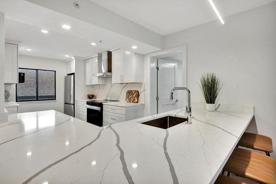 Marina Bluffs is Florida living at its best.  Walk to beaches, parks and shopping. With 4 pools, tennis, pickleball & bocce courts enjoy a sun filled day of activity without leaving home. This unit was completely renovated top to bottom in 2025. The kitchen features stainless appliances including a built-in wine fridge, custom wood cabinetry, high end quartz counters with matching backsplash. and a ventless exhaust hood. Kitchen has also been extended from original layout. and includes breakfast bar with seating for 4. Entire unit has been refinished with luxury White Oak vinyl flooring. Bathrooms have been luxuriously modernized with Italian porcelain tile, frameless shower doors, floating vanities, high efficiency fixtures and LED mirrors. Impact sliders to the balcony & panoramic views Both bathrooms are also equipped with bluetooth enabled speakers built into the exhaust fans. 
New 2025 A/C, Nest Thermostat and All New Electric Panel  finish off this highly detailed oriented renovation. 
Laundry room/storage closet is large enough to be used as a   guest room or home office. Brand new ventless washer and dryer,  quartz counters and cabinetry matching the kitchen. 

This is a true turnkey unit waiting for its new owners to come and enjoy this lifestyle. 

Roofs were completely redone in 2022 and elevators were upgraded in 2024. All assessments have been paid in full and new owners shouldn't be in for any surprises anytime in the near future.

Just half a mile to the beach and Juno Beach fishing pier, as well as the convenience of a Publix shopping center right on the corner with Walgreens, TOO Jays, and  other restaurants and cafes. 
Just a short drive from Love St, a collection of waterfront restaurants and nightlife directly across from the Jupiter Lighthouse. Conveniently located 10 minutes from I95 and less than 25 minutes to Palm Beach International Airport in West Palm Beach.
Jupiter has become the center of the golfing world in recent years as many PGA tour pros call it home and its surrounded by World Class golf courses and country clubs. For the fishing enthusiast Jupiter boasts some of the best fishing in the country due to the deep waters only miles offshore. Many charters and fishing tours are located at any of the many Marinas that can be found throughout Jupiter.