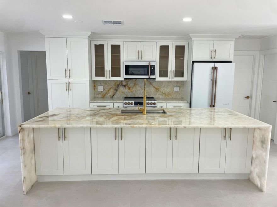 Welcome to the Village of Tequesta and the prestigious Tequesta Country Club Community, where new construction and beautifully renovated homes are shaping a vibrant revitalization. 359 Country Club Drive is a  single story CBS, split floor plan, 4 bed, 2 bath, pool home nestled between private golf courses and Jupiter's stunning Intracoastal Waterway. Fully renovated and completed in 2026 this home features an open floor plan, Cristallo quartzite counter tops, CAFE appliances, smart toilets, closet built-ins, decorative wall panels with a 98" TV and an electric fireplace. Enjoy outdoor entertaining with your own putting green, pool and undercover patio. Close to beaches, dining, shopping, and a community boat ramp with quick access to the Jupiter Inlet. Optional golf and social  memberships available.