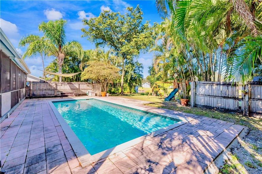 Waterfront Pool Home Great for Entertaining & Relaxing with Family & Friends. Bring Your Boat/RV - NO HOA! Home Features: 4 Bedrooms/4 Bathrooms with a Bright & Open Split Floor Plan, Separate Laundry/Utility Room, Gorgeous New Wood-Tile Flooring, Redone Kitchen with Quartz Countertops & Whirpool Stainless Steel Appliances, Custom Built-Ins and Cabinetry Throughout, and 3 Remodeled Bathrooms. The 4th Bedroom has its own Private Entrance. The 5th Bedroom was Converted into Master Closet. Oversized Lot with Lots of Trees for Privacy, Wraparound Front Porch, Screened Back Patio, Huge Yard with Fire Pit Overlooking the Water. Sought-After Neighborhood of Hillsboro Pines - Close to Walking Trails, Nature Preserves, Major Roads of Transportation, Schools, Shops, Entertaining, & Beaches.