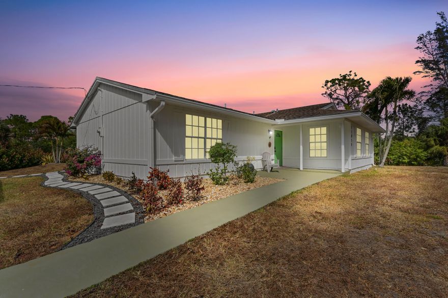 Welcome to your private oasis at 15059 72nd Court N, where modern comfort meets the tranquil, expansive lifestyle of Loxahatchee, FL. This beautiful fully updated home invites you in with its crisp white exterior and a playful, lime-green front door that hints at the vibrant energy within. As you step onto the elegant wood-look flooring, you're greeted by a convenient layout bathed in natural light, featuring a spacious living area perfect for cozying up with family or showcasing your favorite art. The heart of the home is a sleek, contemporary kitchen outfitted with warm wood cabinetry, striking white subway tile, and high-end stainless steel appliances--a true chef's playground that seamlessly overlooks the living spaces. Designed with both relaxation and functionality in mind, the residence offers a stack floor plan that ensures privacy for everyone. The master suite is a serene retreat, complete with a generous walk-in closet and a spa-like ensuite bathroom featuring a luxurious, rain shower head with floor-to-ceiling tile work. Each additional bedroom is thoughtfully styled, providing plenty of room for growing families, a home office, or a creative studio. Practicality is woven into the design with a dedicated laundry room and ample storage solutions, all while maintaining a cohesive, sophisticated aesthetic throughout.

Step outside to discover the ultimate Florida lifestyle! Large French doors lead to a massive, screened-in lanai that serves as an outdoor living area, overlooking a sparkling pool with a cascading waterfall. Whether you're hosting a summer BBQ or enjoying a quiet morning coffee, this space is built for year-round enjoyment. Beyond the enclosure, the sprawling corner lot offers endless possibilities, including a dedicated children's play area with a custom-built playset, a detached air conditioned workshop, pond and plenty of room for your toys or a garden. This is more than just a house; it's a sanctuary where every detail has been crafted to help you live your best life.