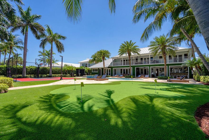 Rare opportunity to own nearly 20,000 SF of direct Intracoastal property near the Hillsboro Inlet with 100' yacht dock in a no-wake zone. This completely remodeled Key West-style estate offers a relaxed luxury lifestyle with a covered terrace, outdoor kitchen, basketball half court, putting green, sauna, cold plunges, and huge pool/spa overlooking the blue Intracoastal waters. Thoughtfully designed floor plan features a downstairs primary suite with dual baths, plus 2 additional beds/baths and laundry room on the main level. Stunning designer kitchen with backlit onyx and top-tier appliances. Upstairs offers 3 more bedrooms, 2 baths, loft, wet bar with full-size refrigerator/microwave, laundry room, and expansive balcony with panoramic views of the estate and Intracoastal waterway.