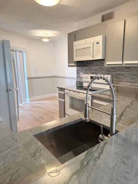 Step into style & comfort in the largest floor plan in the community! Beautifully upgraded 1100sf condo, on the 1st floor. Features sleek New Wood & tile floors, Crown Molding & Designer Baseboards. Cook in a stunning eat-in kitchen w/ wainscoting, New Dishwasher, New Glass Top Electric Range, New Microwave, New Water Heater, Disposal, Refrigerator, Washer- Dryer, New Faucet, New Sink and Newly Upgraded Exotic Countertops. Expansive lake views from the spacious living room & master suite. Best of all each bedroom has a walk-in closet and there's an exterior storage room as an additional storage option! Take in the sunrise/sunsets from the front porch or back patio area. Located just steps from the community pool, to help you fully enjoy the Florida weather - DON'T miss this lakeside gem!
