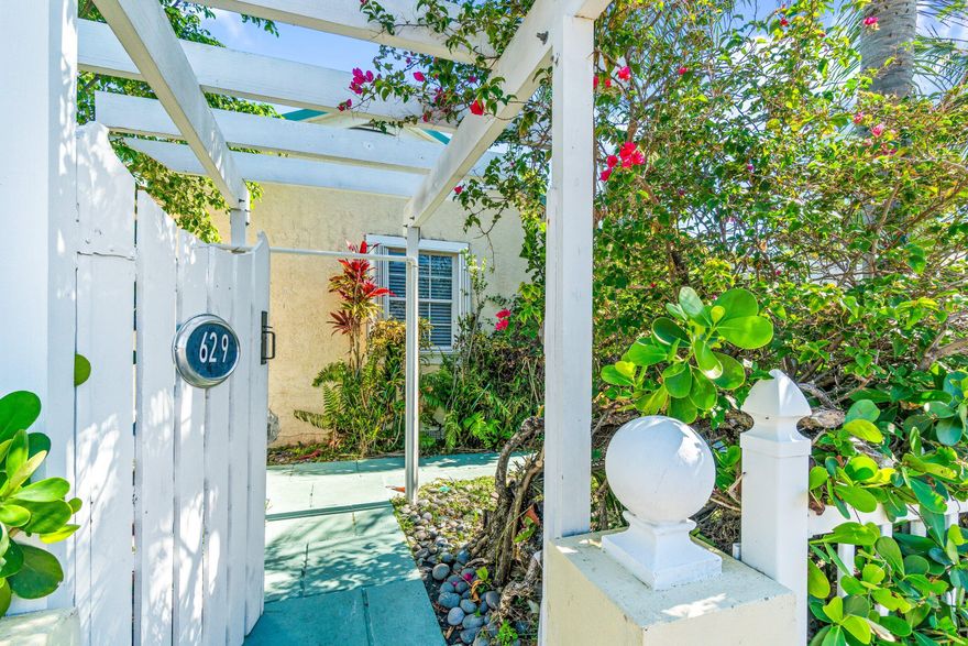 West Palm Beach corner double lot. Hidden behind a white picket fence and wooden gates, this lush tropical property is filled with exotic landscaping , foliage, and coconut palms. The home built in 1939, features French doors, accordion hurricane shutters, a newer metal roof, renovated kitchen & bath, plantation shutters, a fireplace, and a ceiling adorned with wood beams . This eclectic, artsy neighborhood is ideal for homeowners and investors. Situated off Georgia Ave., the property places you minutes. from the intercoastal waterway, downtown, beaches and shopping. This single-family home has room to expand.  A separate freestanding garage, an intimate private courtyard, front yard, side yard and a driveway all within your fenced property. A must-see!!