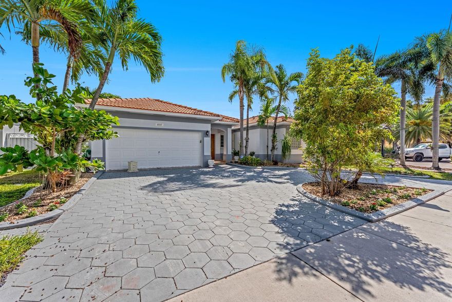 Located in the desirable area of Miami Lakes, inside Genesis Oak Gardens community with (No HOA). This spacious home offers a welcoming layout with beautiful arched entryways that add charm throughout. The open kitchen features plenty of cabinet space and connects seamlessly to the family room, ideal for gatherings and entertaining. Enjoy a separate dining room, living room, and three generously sized bedrooms. The primary suite includes two walk-in closets and a spa-like bath with a soaking tub, bidet, and elegant glass block windows. Step outside to a large fenced backyard with a tiled patio, outdoor kitchen, and room for a pool. This outdoor space is the perfect setting for relaxing or hosting friends and family. The home is ready for you to come in and add your own personal touches.