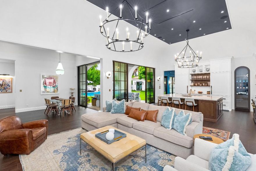 Completely reimagined 6BR/7.1BA estate with beautiful designer finishes throughout. This stunning Courtyard home is located on the highly desirable Wells Road on the Sunny South Side of the street offering an abundance of natural light. Situated on an oversized lot, the home was beautifully renovated in 2024. The welcoming front entry opens to a breathtaking and serene courtyard that feels like your own private oasis complete with beautiful, updated landscaping, covered dining loggia, and large swimming pool. Charming stone path leads to the inviting entry foyer with marble slab flooring. The interiors feature soaring 15' ceilings in most rooms, stunning flooring, and Crestron lighting and sound systems. Elegant formal dining room with built in buffet and China cabinets and gorgeous herringbone wood floors. Gourmet kitchen with top-of-the-line appliances including Blue Star 60'' range with French top, dual Miele dishwashers, and Sub Zero refrigerator, freezer, and refrigerator drawers. Leeds cabinets, custom hardware, and temperature-controlled wine display. Oversized chef's island features sink with Waterworks faucet and seating for four. Fantastic open floor plan, perfect for entertaining, with the kitchen open to the family room and breakfast area. Spacious primary suite with striking detailing, two large walk-in closets, stunning dual bathrooms, and private patio. Additional guest suites with en-suite bathrooms. Fabulous office/additional guest suite. The custom Leeds bathrooms also feature Paris Ceramic and Waterworks tile and hardware. Second floor addition features convenient separate entry, guest suite, and large gym with sauna. Fabulous pool cabana with full bath and kitchenette complete with Sub Zero beverage center and Miele dishwasher and ice maker. Additional highlights include full house generator, newly installed irrigation system, and so much more.