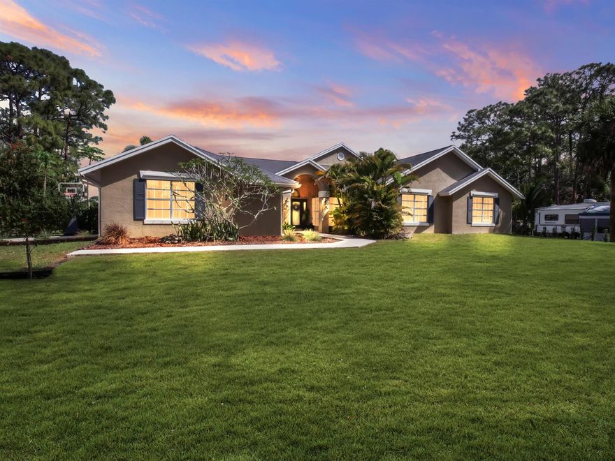 Modern 4-Bedroom, 3-Bath Home with Pool, RV Income Potential, Tropical Landscaping on 1.15 Acres in Loxahatchee Step into the refined essence of Florida living. This fully renovated 4-bedroom, 3-bathroom residence sits on a lushly landscaped 1.15-acre lot in one of Loxahatchee's most desirable neighborhoods. Combining modern comfort with elegant style, this turnkey home is ready for move-in. Interior Features An open-concept layout welcomes you with spacious living areas, stylish design details, and abundant natural light. Premium porcelain tile and laminate flooring flow throughout the home, while custom closet doors and sleek finishes elevate its modern character. The stunning kitchen features chic cabinetry, updated fixtures, and a layout perfect for both everyday living.