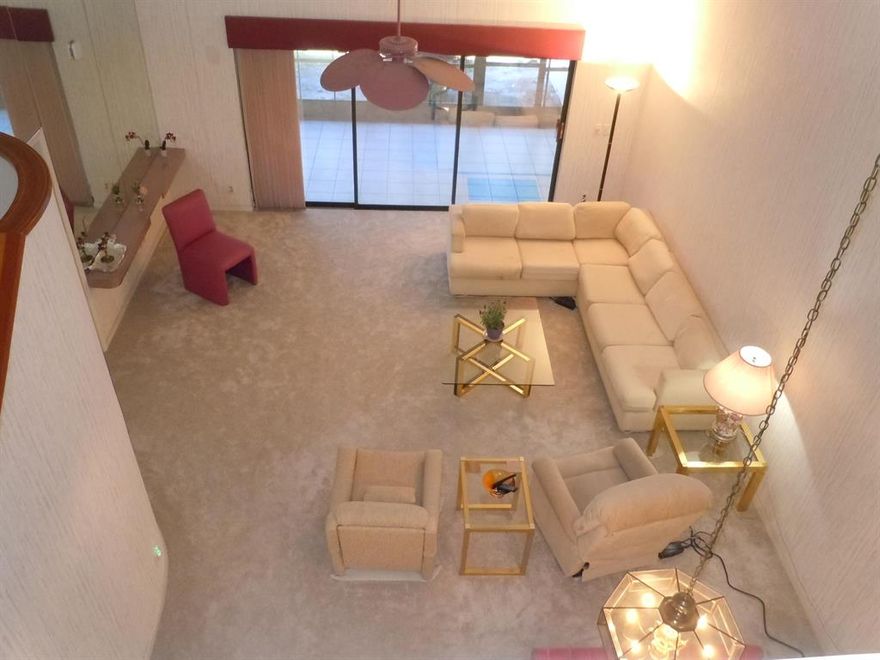 Very spacious 3 bedroom 2 1/2 bath 1 car garage townhouse in Boca Ridge. The large master bedroom is on the first floor with the other 2 bedrooms on the second floor. All the popcorn has been removed and new carpet has been installed throughout the living areas. Living room and dining room gives you all the room to have as many guests you want without being crowded. The very expansive screened in back porch that has an insulated roof and storm pull down shutters is another area to enjoy looking out to the pond, tennis court, and wildlife. Enjoy the new uptown Boca shopping center. The community features a heated pool and tennis court and is a pet friendly community.
 Don't wait or it will be gone.