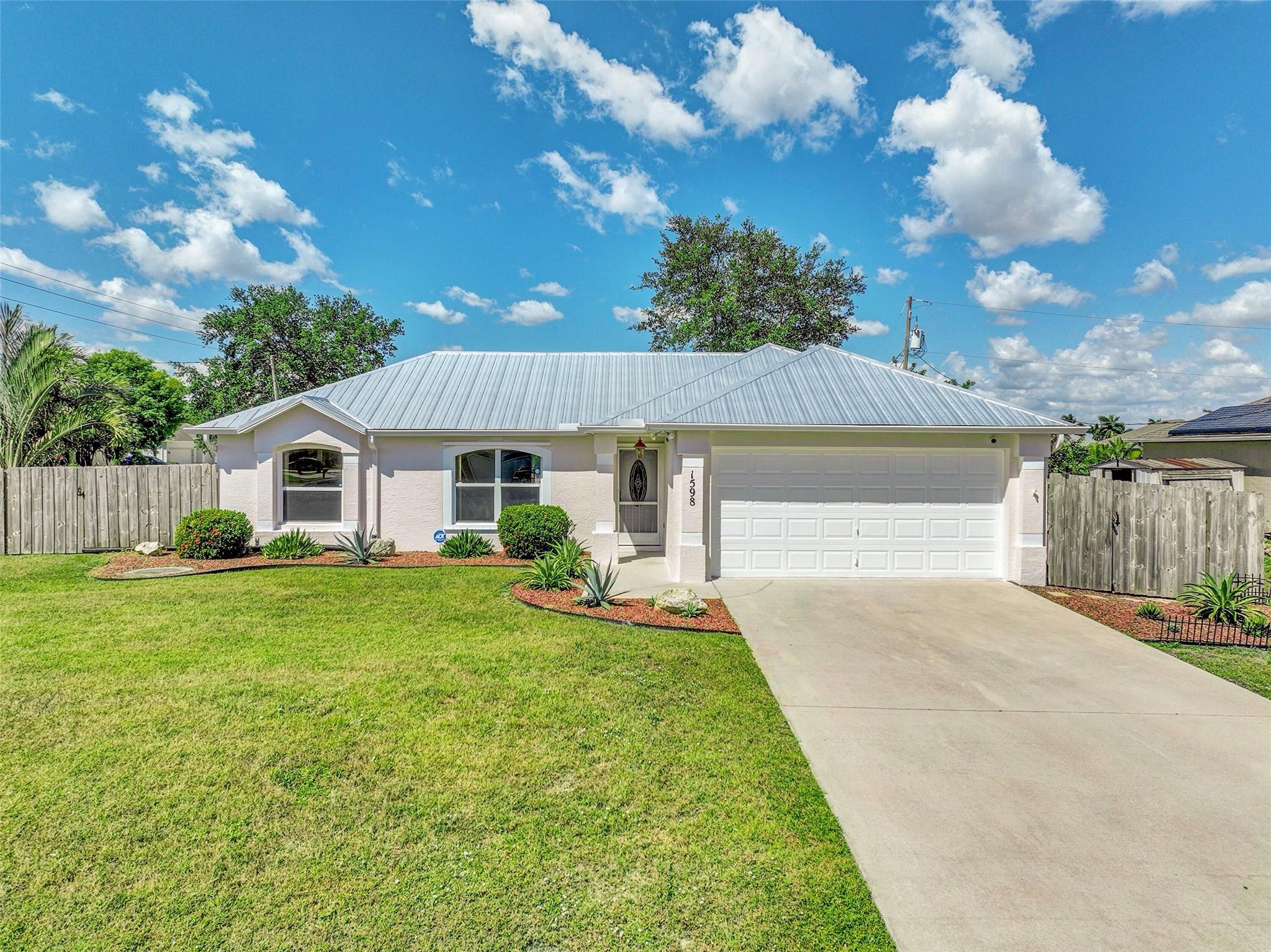 Welcome to your perfect Florida retreat! This beautiful 3-bedroom, 2-bathroom pool home in the heart of Port St. Lucie situated on a desirable corner lot with a metal roof and hurricane protection for peace of mind. Vaulted smooth ceilings, recessed lightning , tile floors throughout with a brigh and open layout. The spacious 2-car garage adds extra convenience. Enjoy the best of indoor-outdoor living with a private pool, screened lanai, and a fully fenced yard—pets welcome! Ideally located near highways, schools, parks, shopping, and dining. New washer and dryer, includes lawn care + pool maintenance. Move-in ready and available now for annual or seasonal rental—don’t miss this gem! Call for an appointment today.