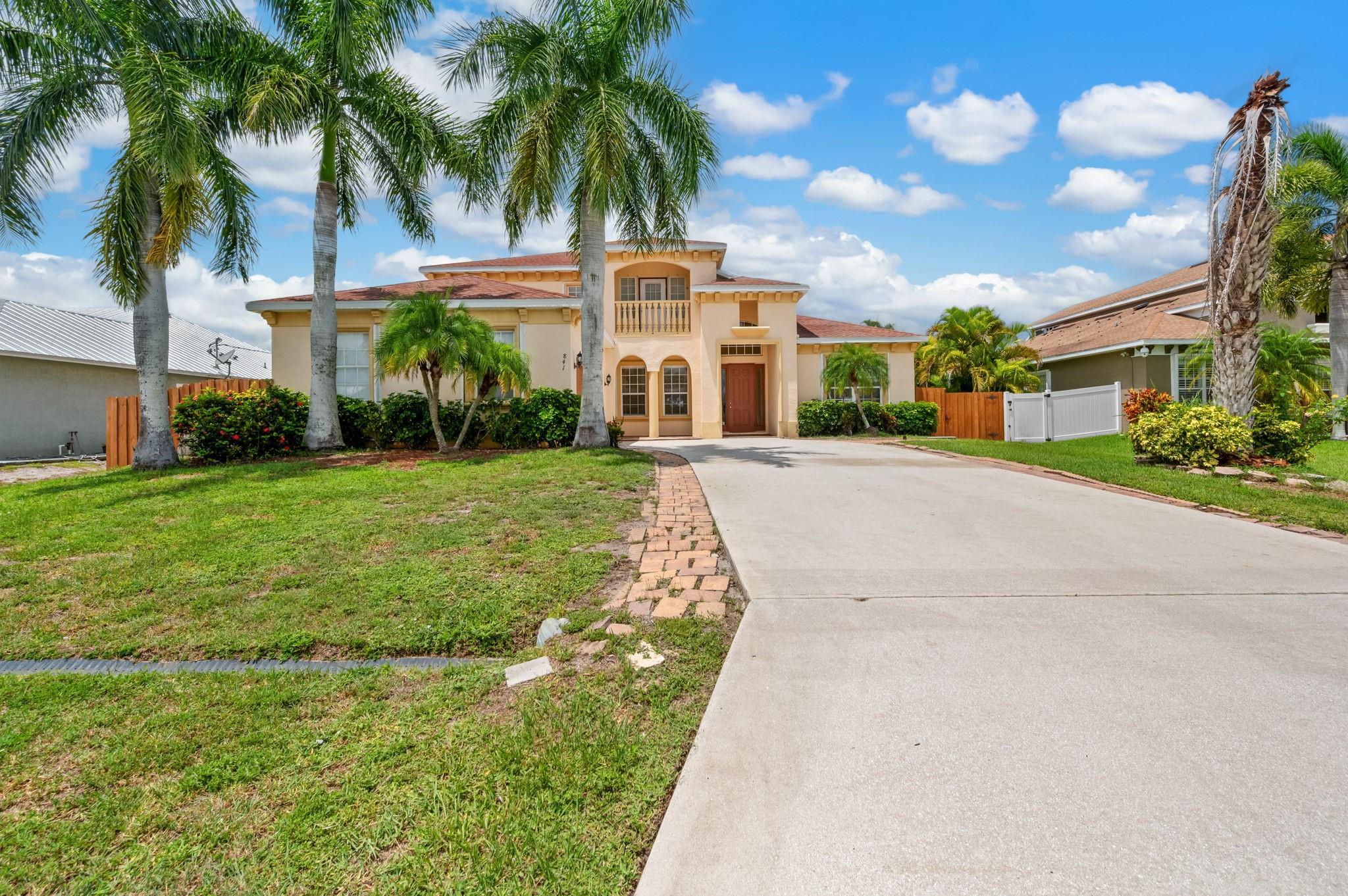 This is an amazing opportunity to own a magnificent architectural unique home with over 5000 SF . The grand foyer entrance leads to breathtaking soaring ceilings, open airy staircase and large loft with exterior railed balcony. The possibilities are endless with 5 bedrooms, including a mini master suite, 3.5 bathrooms, and 4 way split floor plan. Very light and bright with clerestory windows in huge living area plus wall to wall sliding doors that look out to extended 2 story screened paver patio. Gourmet kitchen features new appliances, granite counters, large under stair pantry and island with breakfast bar. Spacious master suite has an extra private room for office, study or additional storage. Separate HVAC for each floor. NO HOA here to answer to. Call for your showing today.